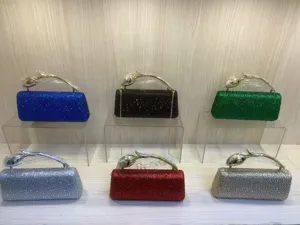 Macro view of six colorful sparkling rhinestone evening clutch bags with rose handles.
