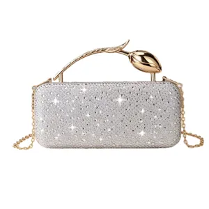 Elegant silver rhinestone evening clutch bag with gold tulip handle and chain strap