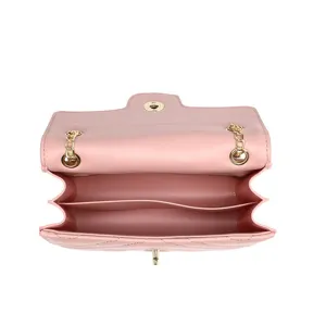 Open interior view of pink quilted leather chain shoulder bag with compartments