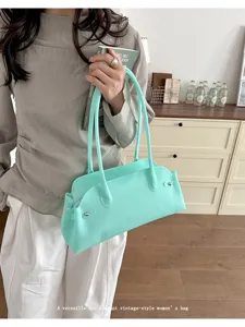 Elegant mint green PVC baguette shoulder bag featuring a stylish vintage jelly texture