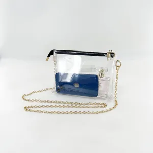 Clear PVC jelly crossbody bag with gold chain strap showing phone and perfume inside
