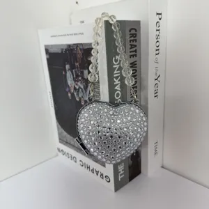 Elegant mini heart-shaped lipstick bag with sparkling rhinestones and clear bead strap detail