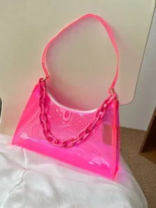 Vibrant neon pink transparent PVC jelly underarm bag with matching chain handle