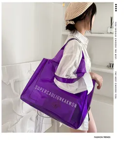 Detailed lifestyle shot of a large purple transparent PVC jelly tote bag with lettering