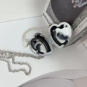 Detailed interior view of luxury rhinestone heart mini bag with dual internal mirrors