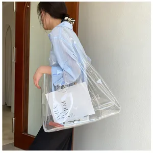 Detailed lifestyle view of a large-capacity transparent PVC jelly tote bag with lettering.