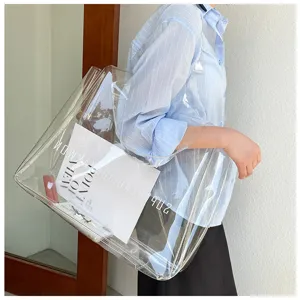 Model carrying a large transparent PVC tote bag showing its spacious interior details