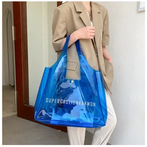 Stylish large blue transparent PVC jelly tote bag with white minimalist lettering detail