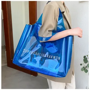 Detail shot of a large blue transparent PVC jelly tote bag with white letter print