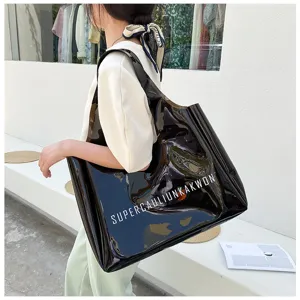 Detailed view of the large PVC jelly tote bag featuring bold white letter printing.