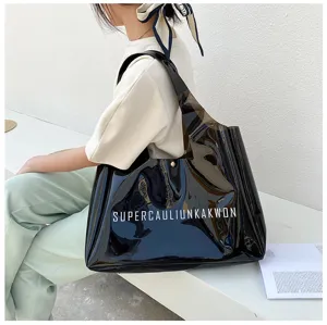 Stylish model carrying a large black semi-transparent PVC jelly tote bag in a casual setting