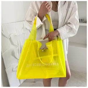 Large neon yellow transparent PVC jelly tote bag with white lettering for women