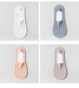 Detail view of women solid color ice silk low cut invisible boat socks in four soft shades.