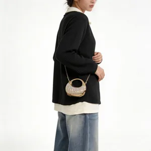 Detail view of a gold metallic evening bag with crystal embellishments and chain strap