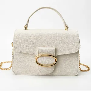 Elegant small white handbag with a textured finish and a stylish gold chain strap.