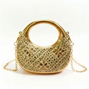 Detailed view of elegant gold rhinestone evening clutch bag with circular handle