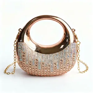 Close-up of elegant rose gold evening bag featuring shimmering rhinestones and round handle