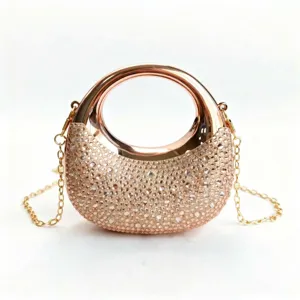 Macro view of the elegant rose gold rhinestone detail on this luxury evening bag
