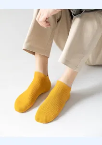 Gros plan détaillé de chaussettes courtes jaunes pour hommes avec bord côtelé confortable.