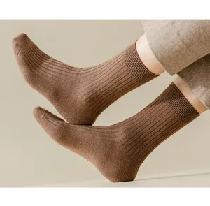 Detailed close-up of men's winter brown ribbed wool socks, cozy warm thermal casual daily wear.