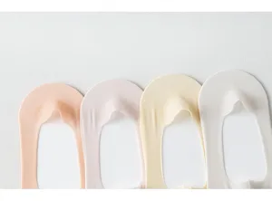 Closeup of summer women's solid color shallow invisible ice silk socks, anti-slip cotton bottom design.