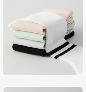 Detailed view of sporty long socks in assorted pastel colors neatly stacked on a clean surface.