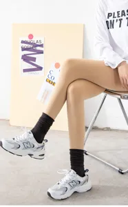 Detailed view of fleece-lined skin-colored leggings worn by model with stylish socks.