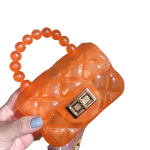 Trendy vibrant orange quilted jelly mini handbag with bead handle and golden lock