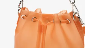 Detail of frosted orange TPU bucket bag with silver drawstring grommets