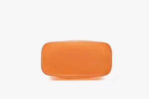 Detail view of the reinforced bottom of an orange frosted TPU jelly bucket bag