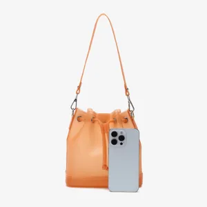 Close-up of frosted orange TPU bucket bag showing size comparison with a smartphone.