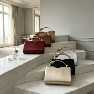Elegant evening clutch bags with gold rose branch handles in various colors