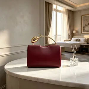 Luxury burgundy evening clutch bag featuring a creative gold rose branch designer handle