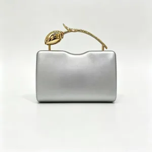 Elegant silver evening clutch bag with creative golden rose branch handle for gala.