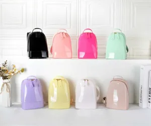 Detailed view of mini PVC jelly backpacks in multiple colors displayed in a bright studio.