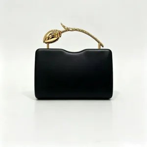 Elegant black rectangular evening clutch featuring a creative golden rose branch handle