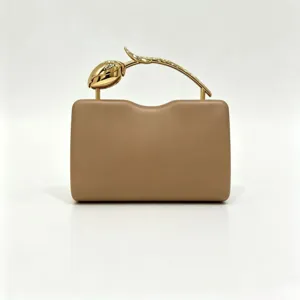 Elegant tan dinner clutch bag featuring a creative gold rose-branch handle.