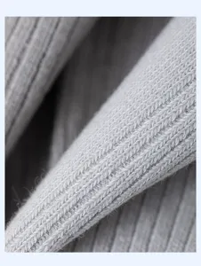 Close up macro texture shot of grey ribbed knit cotton fabric for men socks detail.
