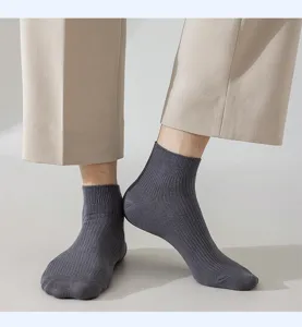 Close-up detail of dark grey ribbed men's short socks, showcasing soft knit texture.