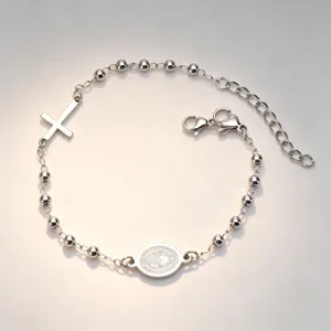 Detailed view of stainless steel rosary bracelet featuring cross and oval saint medallion