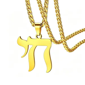 Close-up detail of a gold Hebrew Chai symbol pendant on a matching wheat chain.