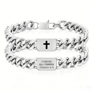 Close-up of stainless steel Cuban link bracelets with cross and Bible verse engraving