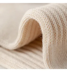 Close-up detail of breathable cotton knit socks fabric showing fine texture and elasticity.