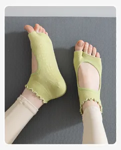 Detail shot of green non-slip yoga socks with open back and toe separation design.