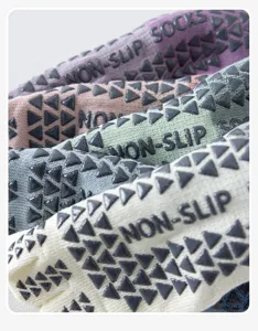 Detailed shot of non-slip five-toe yoga socks with grip dots for pilates and fitness.