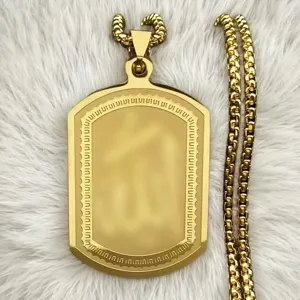 Close-up of golden stainless steel rectangular pendant with intricate border on white fur