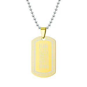 Detail view of gold and silver dog tag pendant with engraved Thai Five Lines script
