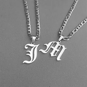 Detailed view of retro Gothic initial J and M pendants on silver-tone stainless steel chains.