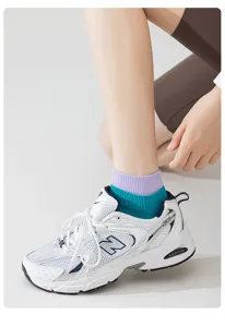Cotton short socks detail view, vibrant layered purple and teal ankle socks for women.