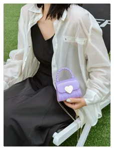 Detailed view of sweet purple mini PVC jelly bag featuring gold heart lock and chain strap